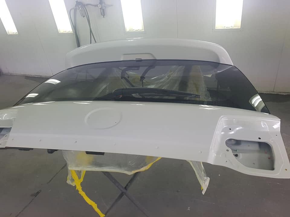 A Landcruiser tailgate in the spray booth after painting